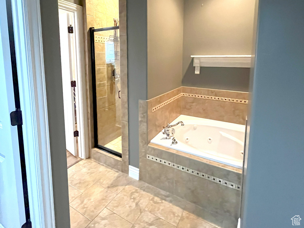 Full bathroom with a stall shower, a whirlpool tub, and tile patterned floors