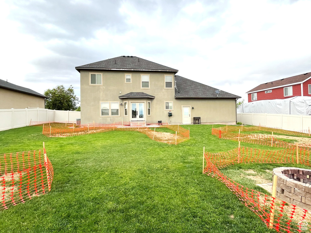 Rear view of house featuring a garden and stucco siding