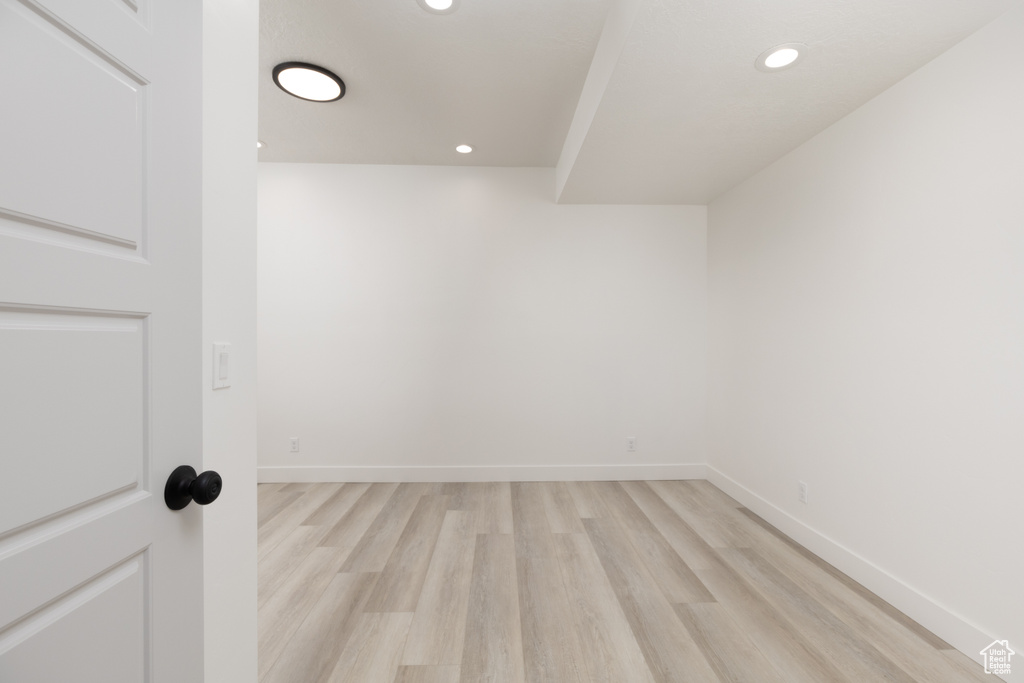 Bonus room with light wood-style floors, recessed lighting, and baseboards