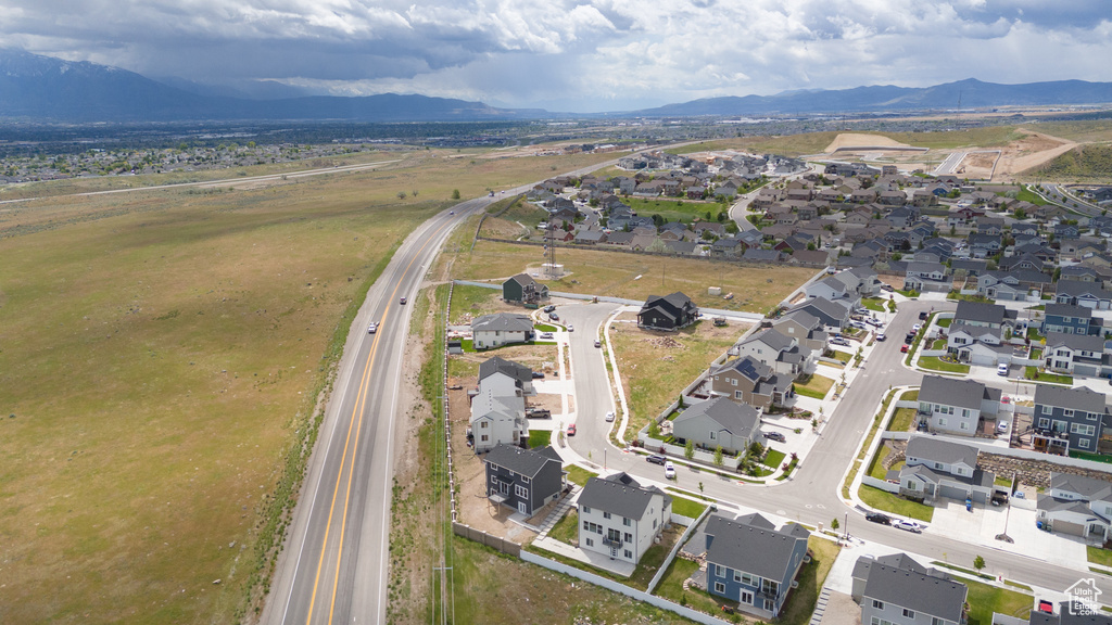 Aerial view of property's location featuring nearby suburban area and a mountain backdrop