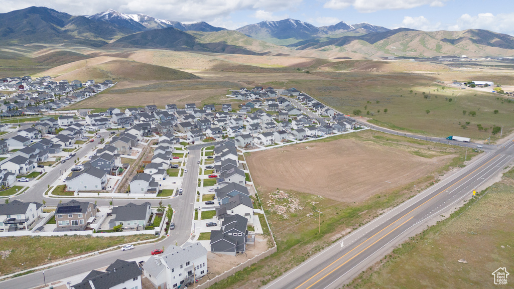 View of property location featuring nearby suburban area and a mountain backdrop