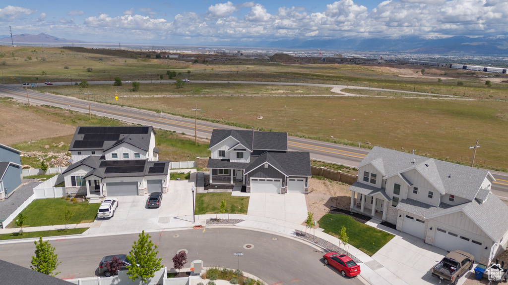Aerial view of residential area featuring a mountainous background