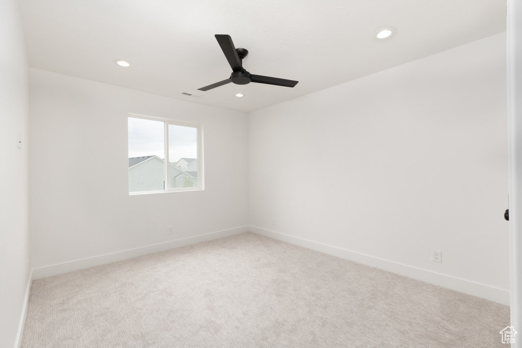 Carpeted empty room with ceiling fan, recessed lighting, and baseboards