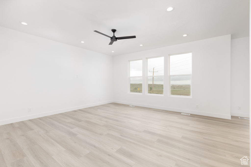 Unfurnished room featuring recessed lighting, a ceiling fan, light wood finished floors, and baseboards