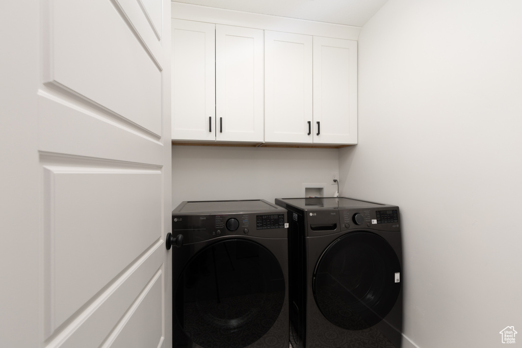 Clothes washing area with washer and dryer and cabinet space