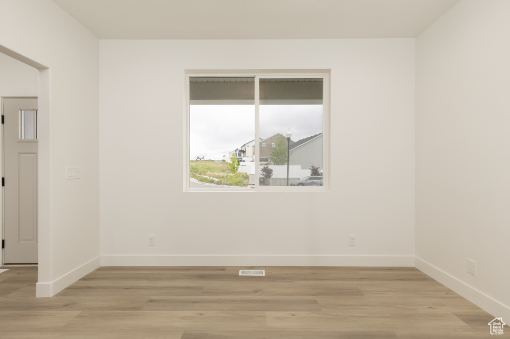 Empty room featuring baseboards and light wood-style floors