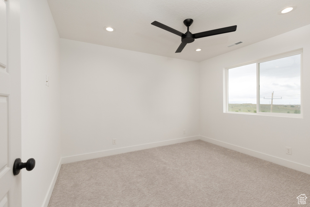 Carpeted empty room with a ceiling fan, recessed lighting, and baseboards