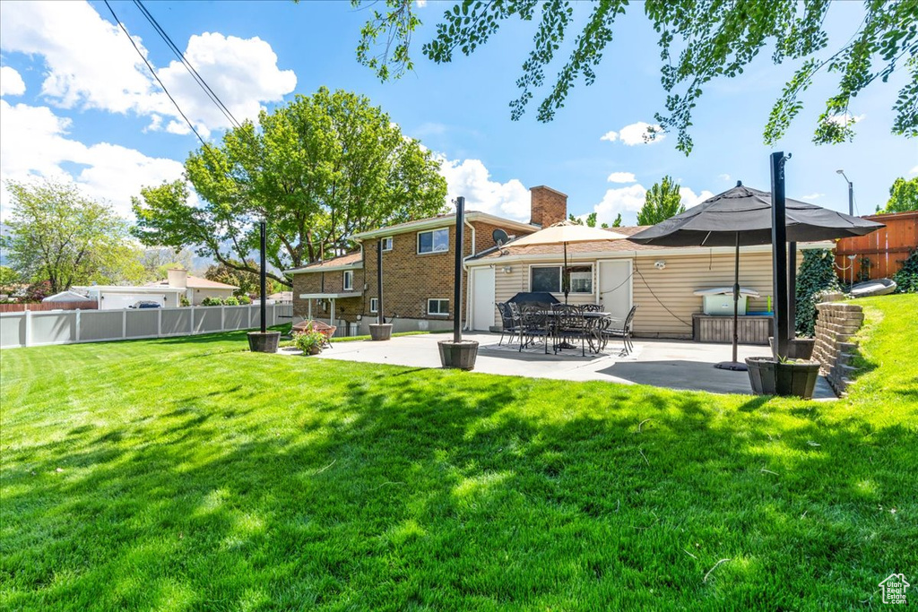 Rear view of property with a patio area and a chimney