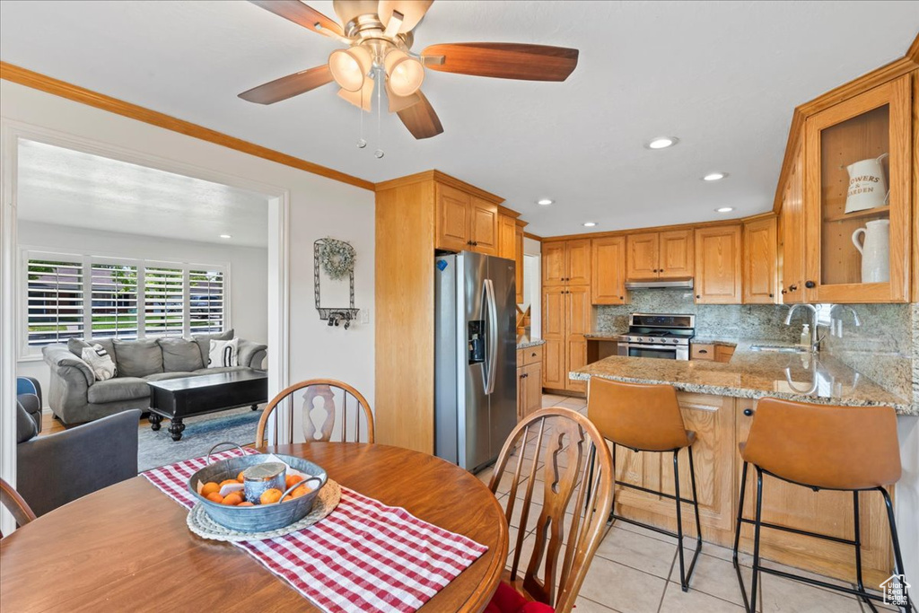 Dining space with light tile patterned floors, recessed lighting, and ceiling fan
