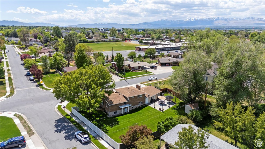 Aerial view of residential area featuring a mountainous background