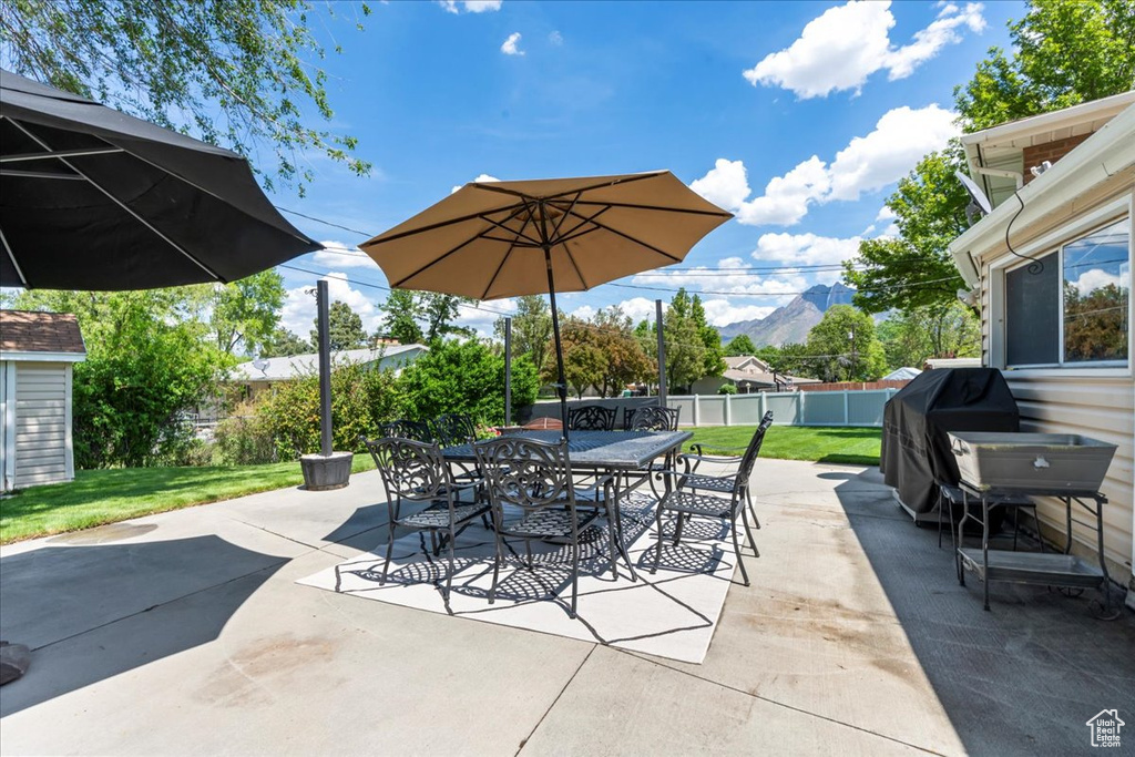 View of patio featuring a mountain view and outdoor dining space