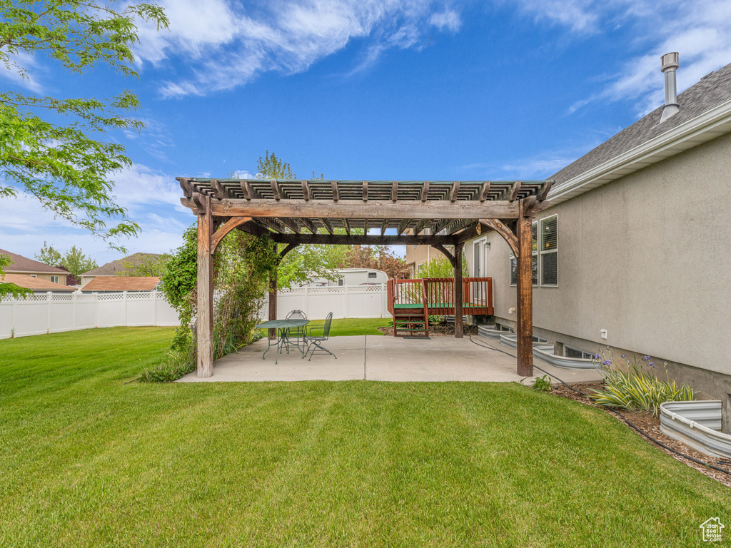 View of yard featuring a pergola and a patio area