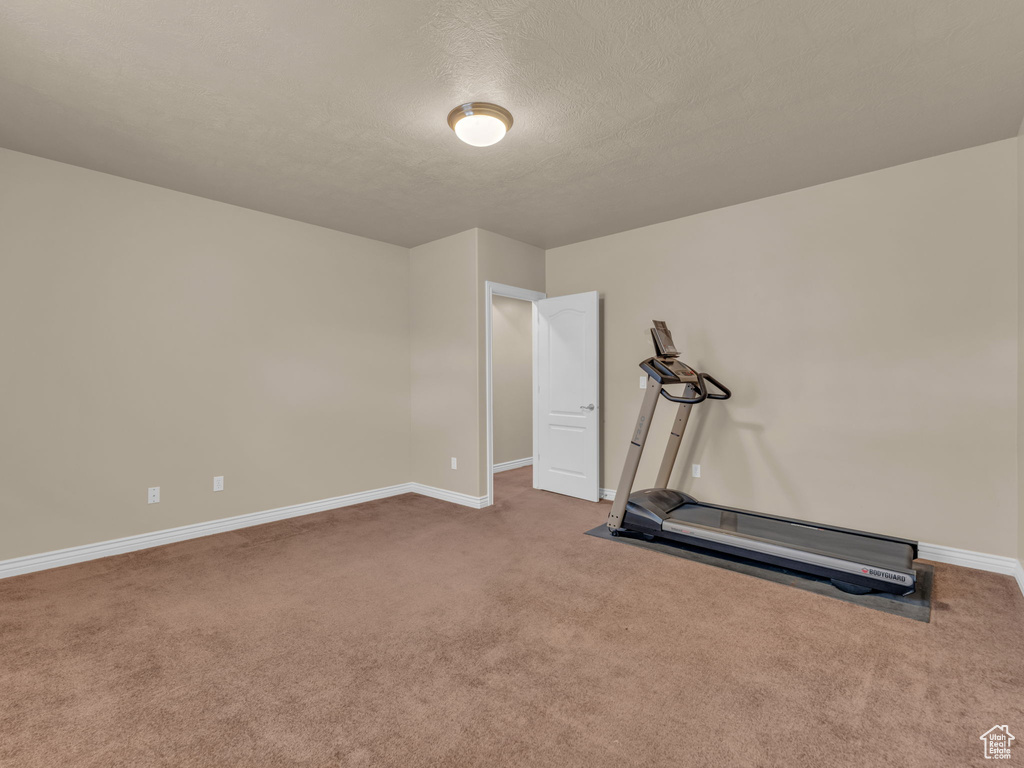Workout area with carpet flooring and baseboards