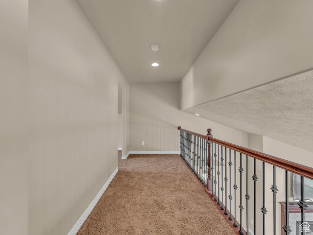 Hall with baseboards, carpet, and recessed lighting