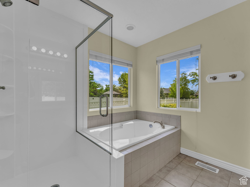 Bathroom with tile patterned flooring, a stall shower, and a bath