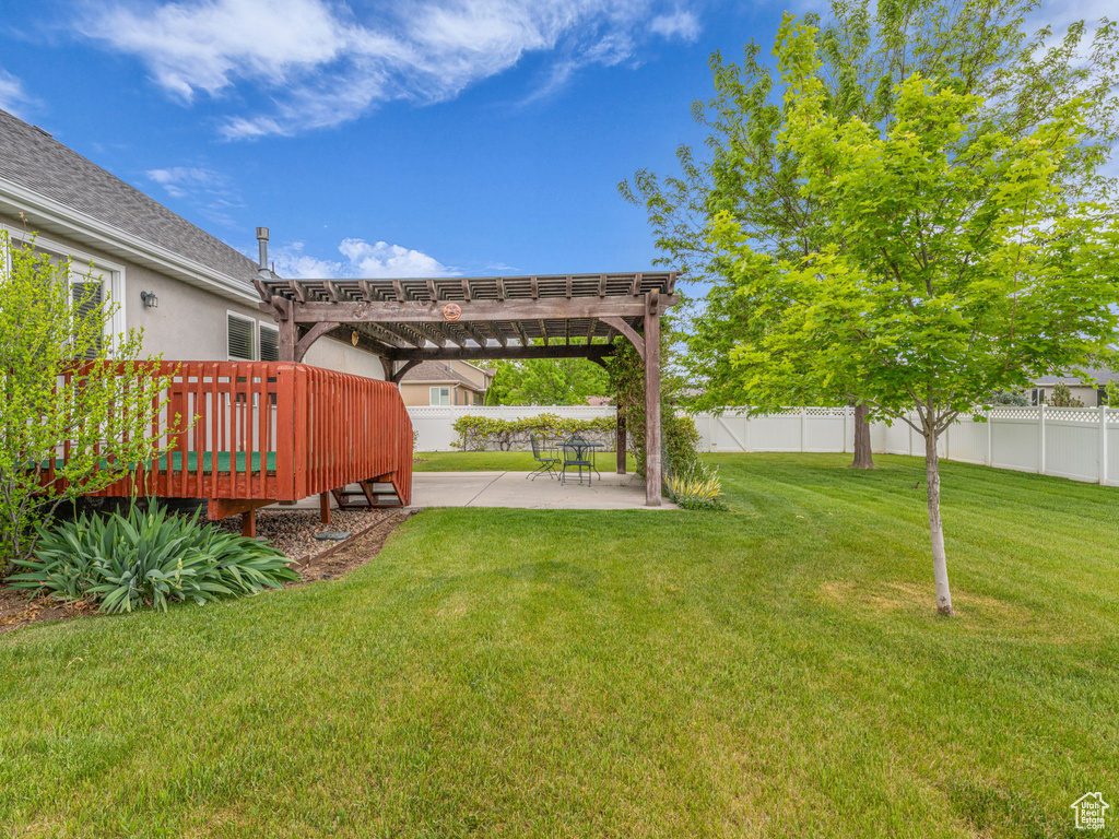 View of yard with a pergola, a patio, and a deck