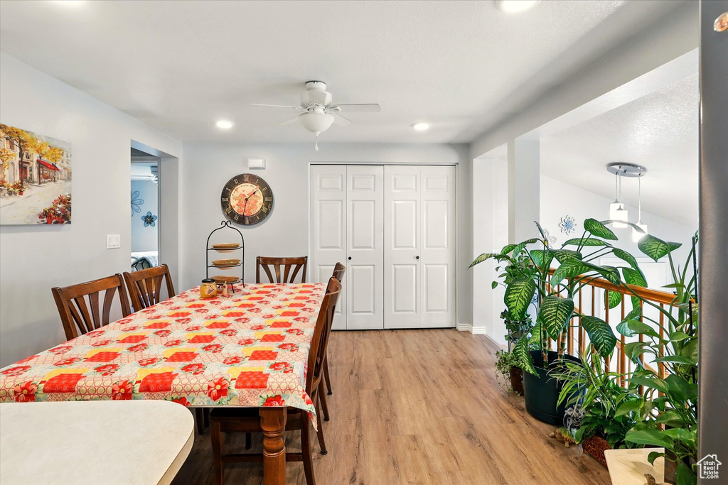 Dining room with ceiling fan, light wood finished floors, and recessed lighting