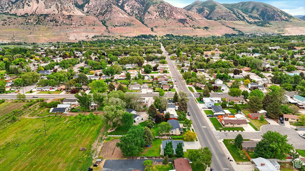 Aerial overview of property\'s location featuring mountains and nearby suburban area