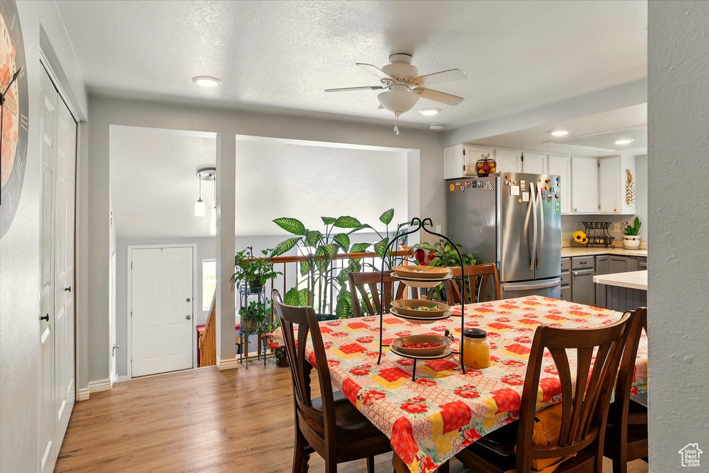 Dining room featuring ceiling fan, light wood finished floors, recessed lighting, and baseboards