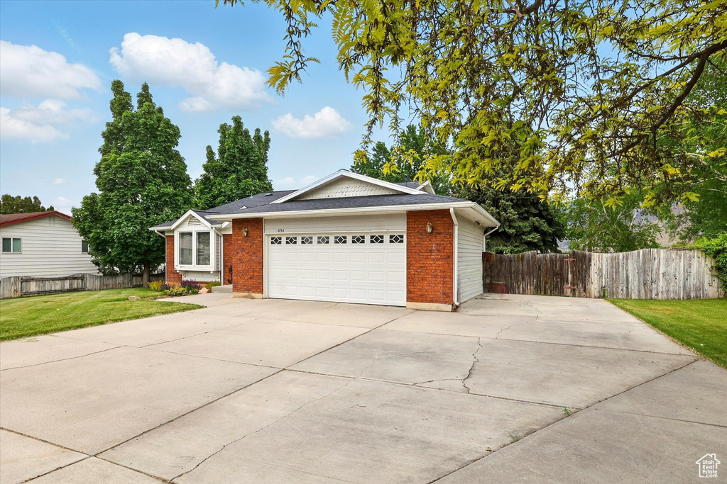 Ranch-style home featuring brick siding, concrete driveway, and a garage