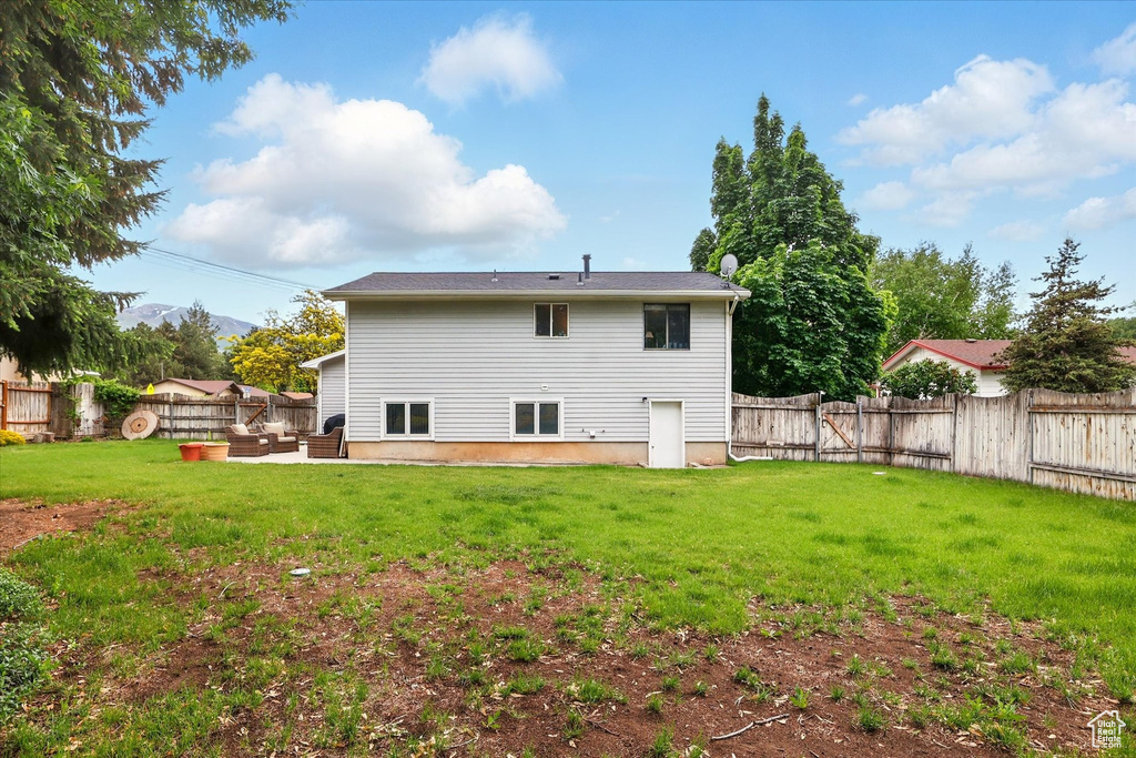 Rear view of property featuring an outdoor living space and a patio