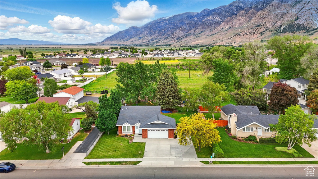 Aerial view of residential area featuring a mountainous background