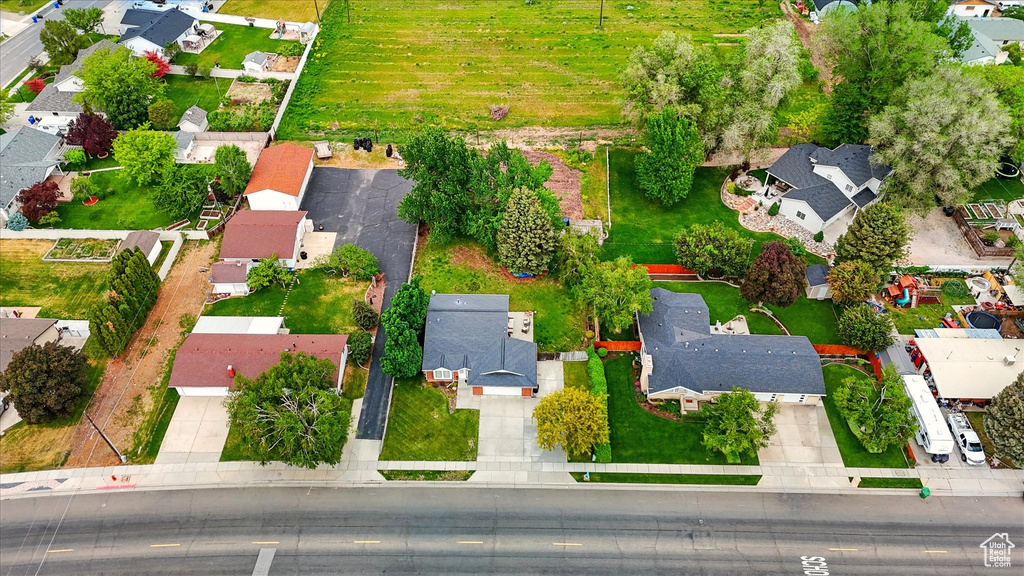 Aerial view of property and surrounding area with nearby suburban area