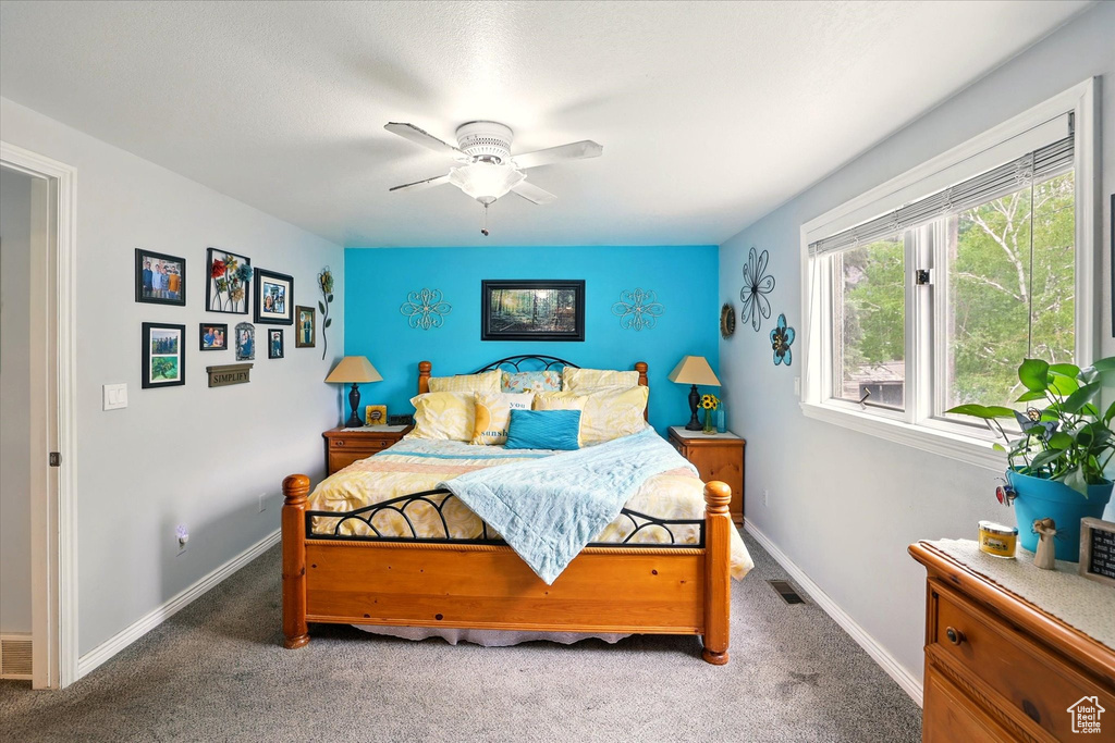 Bedroom featuring carpet, ceiling fan, and baseboards