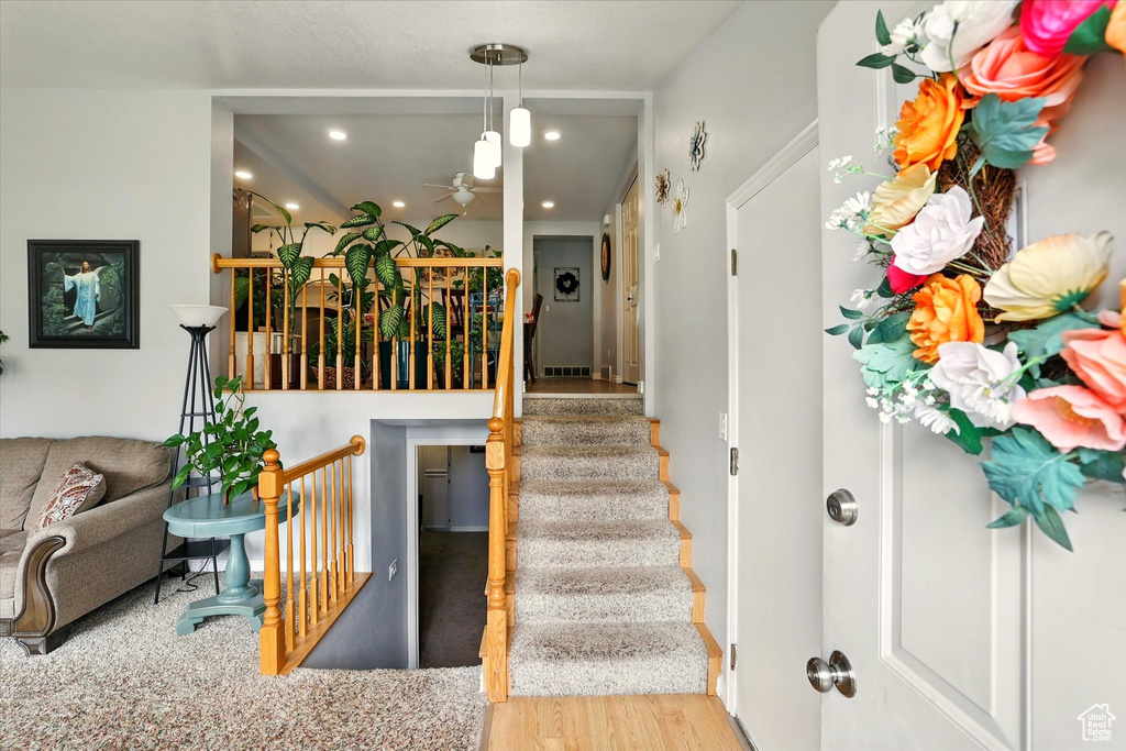 Staircase featuring ceiling fan, recessed lighting, and wood finished floors
