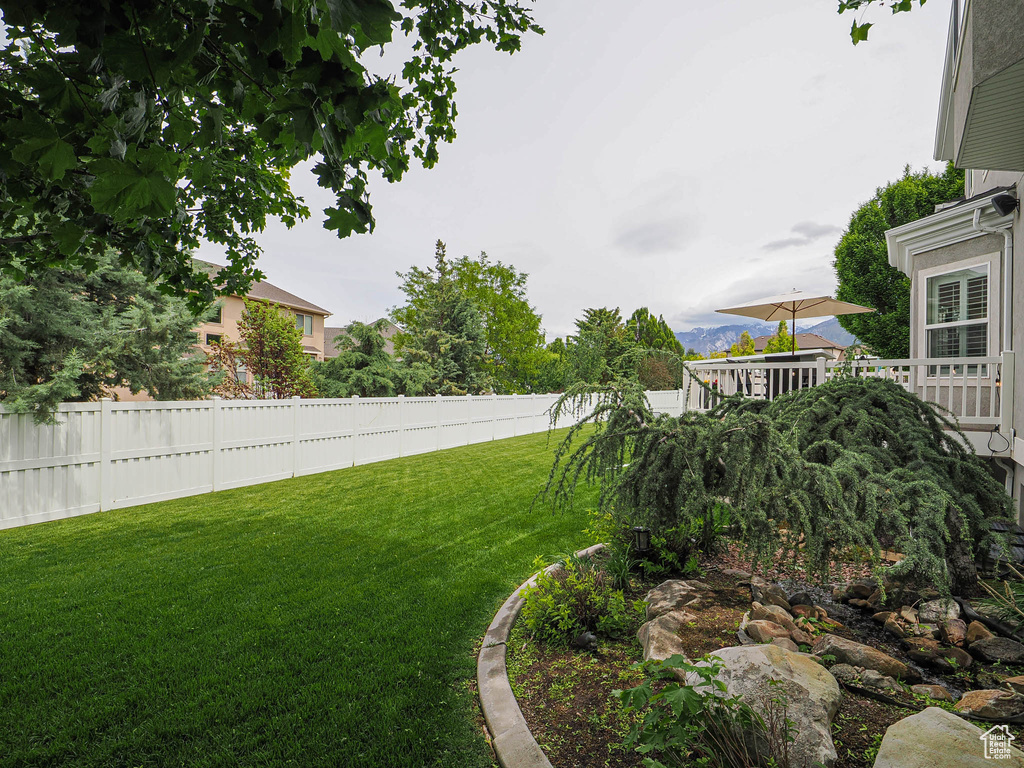 View of yard featuring a wooden deck