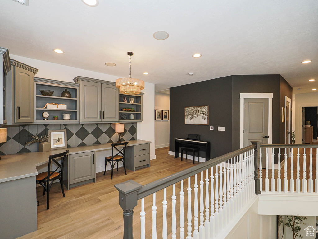 Kitchen featuring open shelves, gray cabinetry, light wood finished floors, recessed lighting, and light countertops