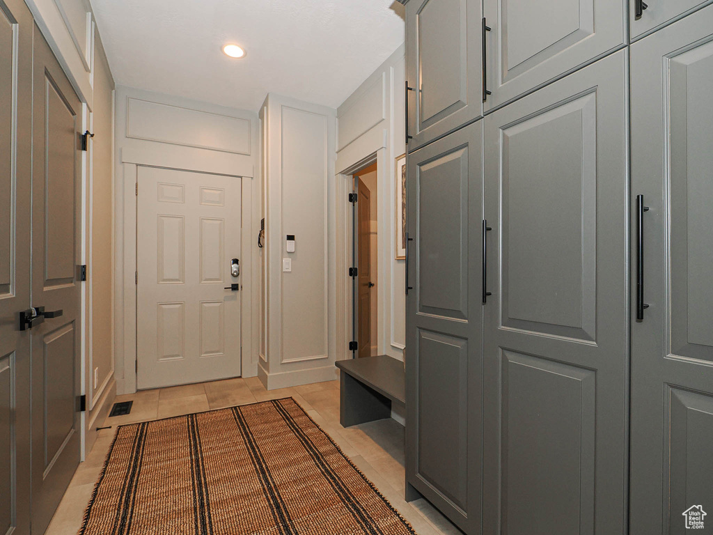 Mudroom with light tile patterned floors and recessed lighting