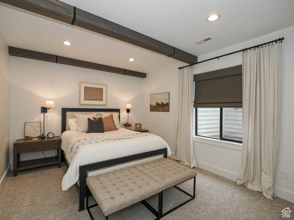 Carpeted bedroom featuring baseboards, recessed lighting, and beamed ceiling