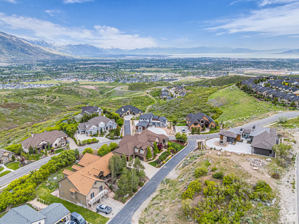 Aerial view of property and surrounding area featuring nearby suburban area