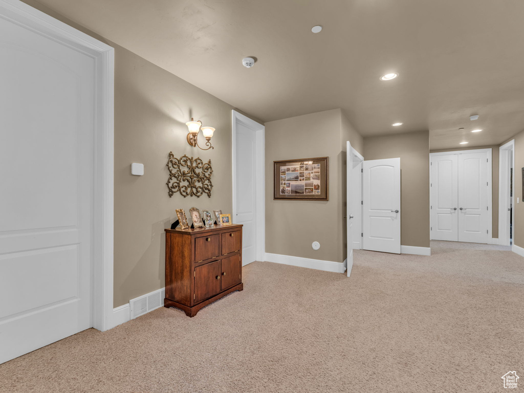 Basement with light colored carpet, recessed lighting, and baseboards