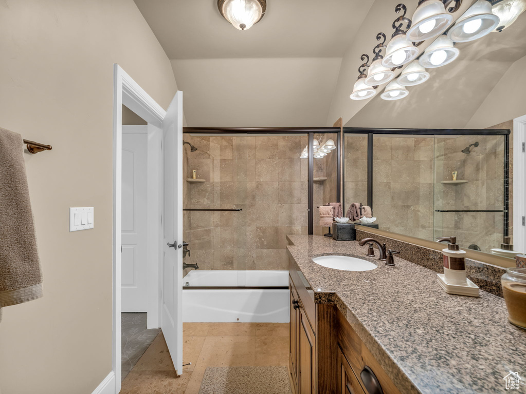 Full bath with vanity, combined bath / shower with glass door, and tile patterned flooring