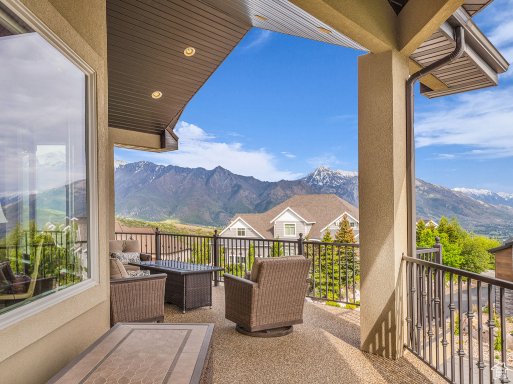 View of patio with a balcony and a mountain view