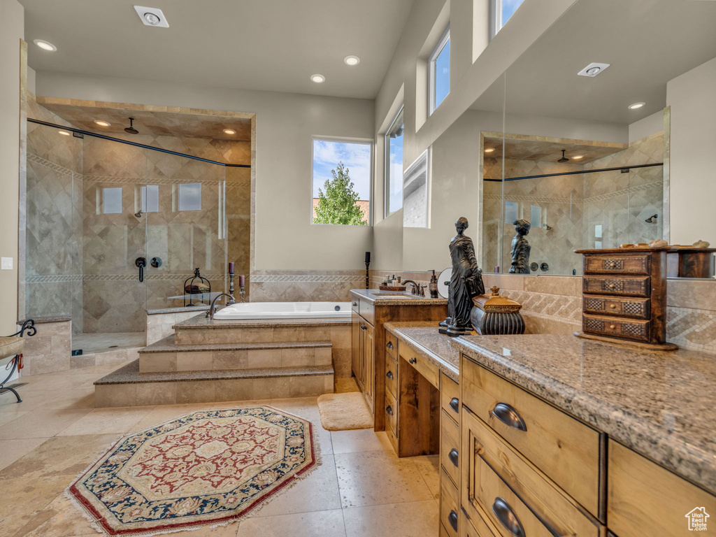 Full bathroom with a shower stall, a garden tub, recessed lighting, and vanity
