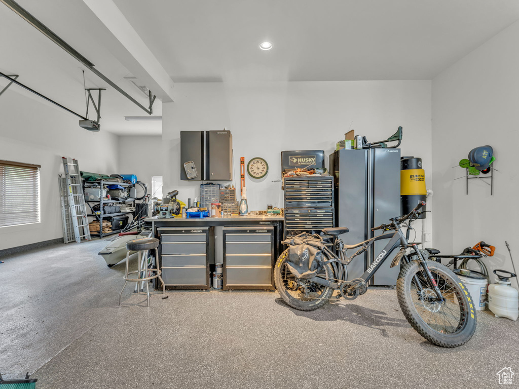 Garage with refrigerator and recessed lighting