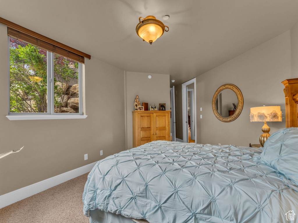 Bedroom featuring carpet floors and baseboards