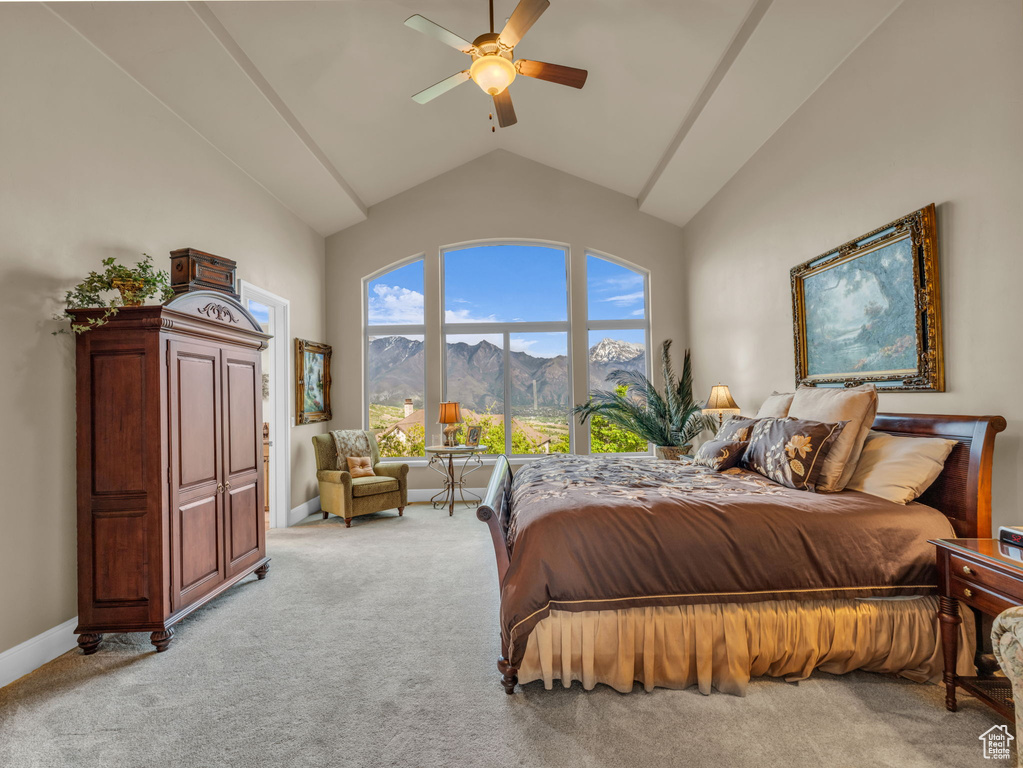 Bedroom featuring high vaulted ceiling, a mountain view, light colored carpet, baseboards, and a ceiling fan