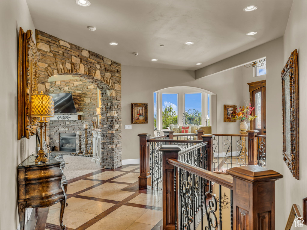 Hall with inlaid floor details, recessed lighting, an upstairs landing, and baseboards