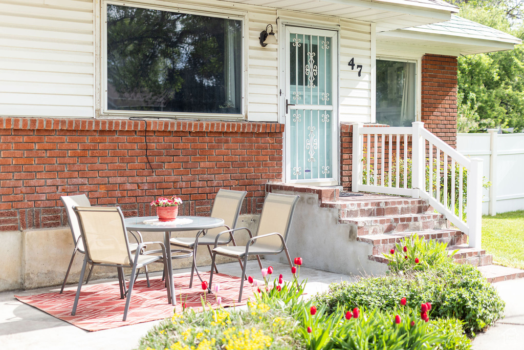 Property entrance featuring brick siding