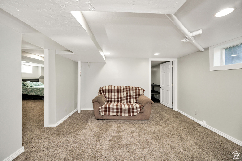 Living area featuring carpet, baseboards, and recessed lighting