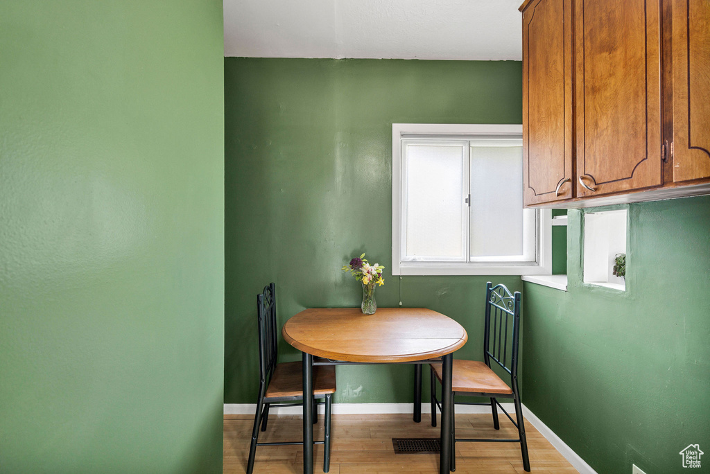 Dining space featuring wood finished floors and baseboards