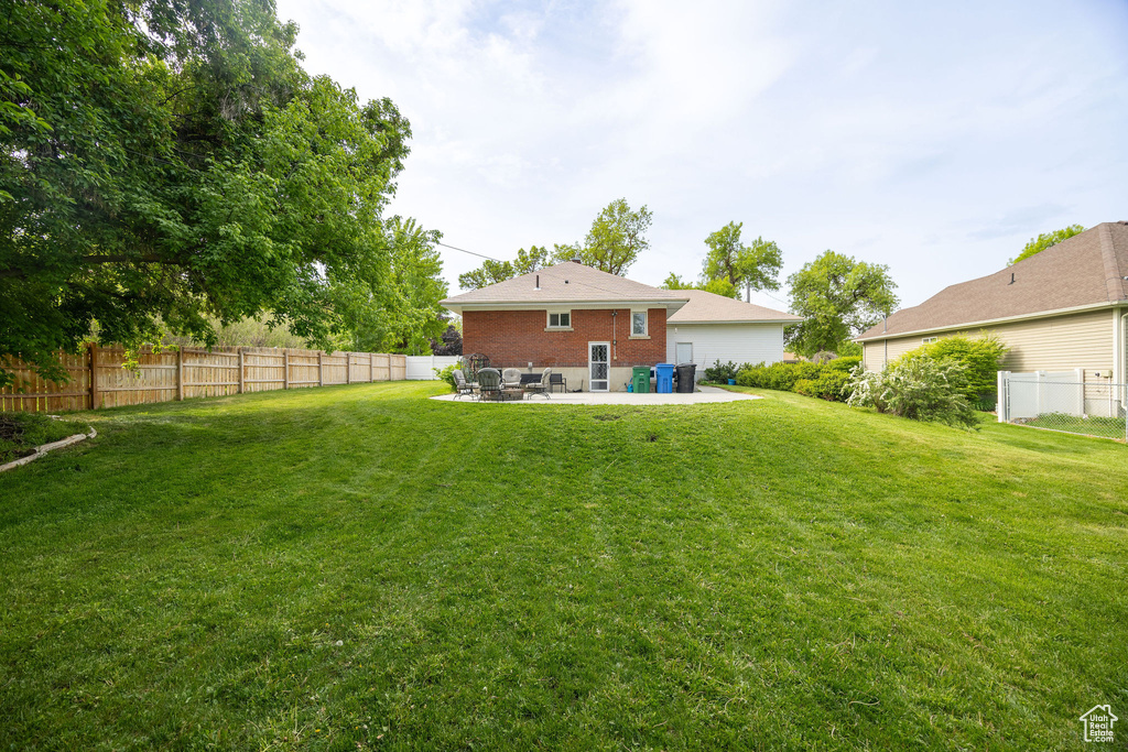Back of house featuring a patio and brick siding