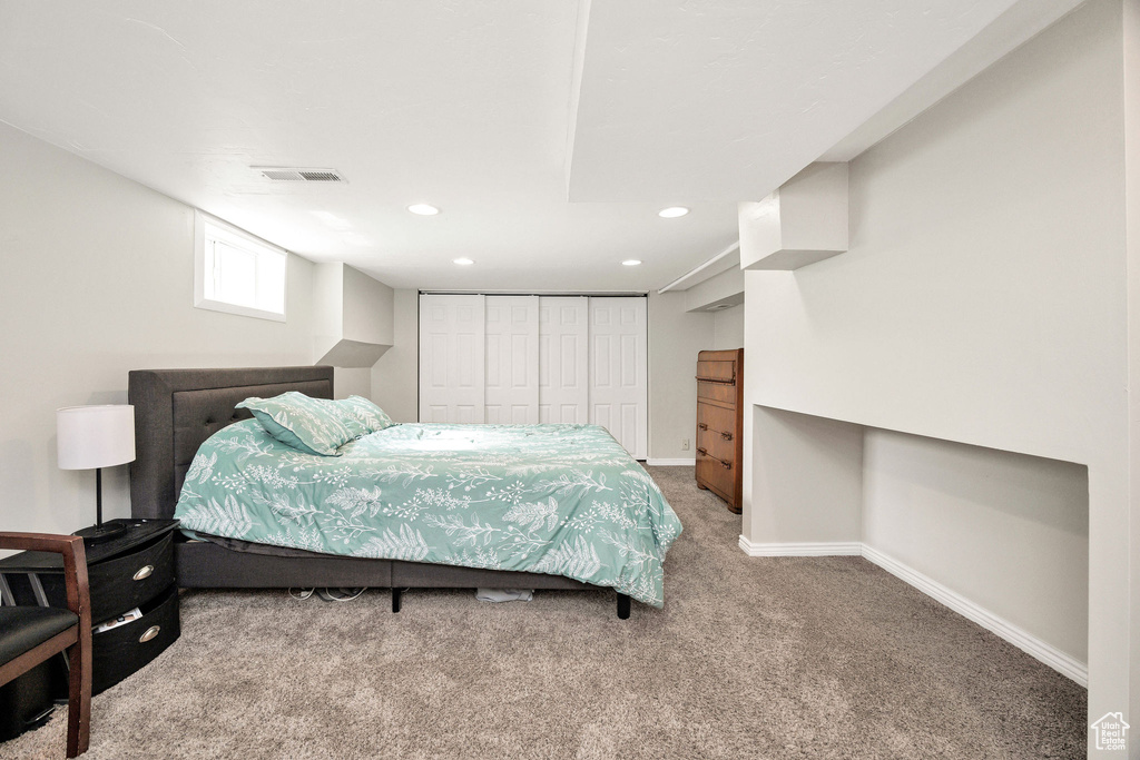 Carpeted bedroom featuring a closet, recessed lighting, and baseboards