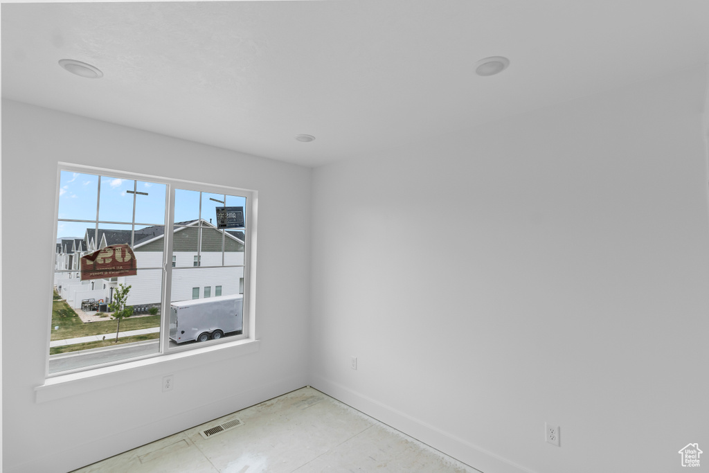 Spare room featuring baseboards