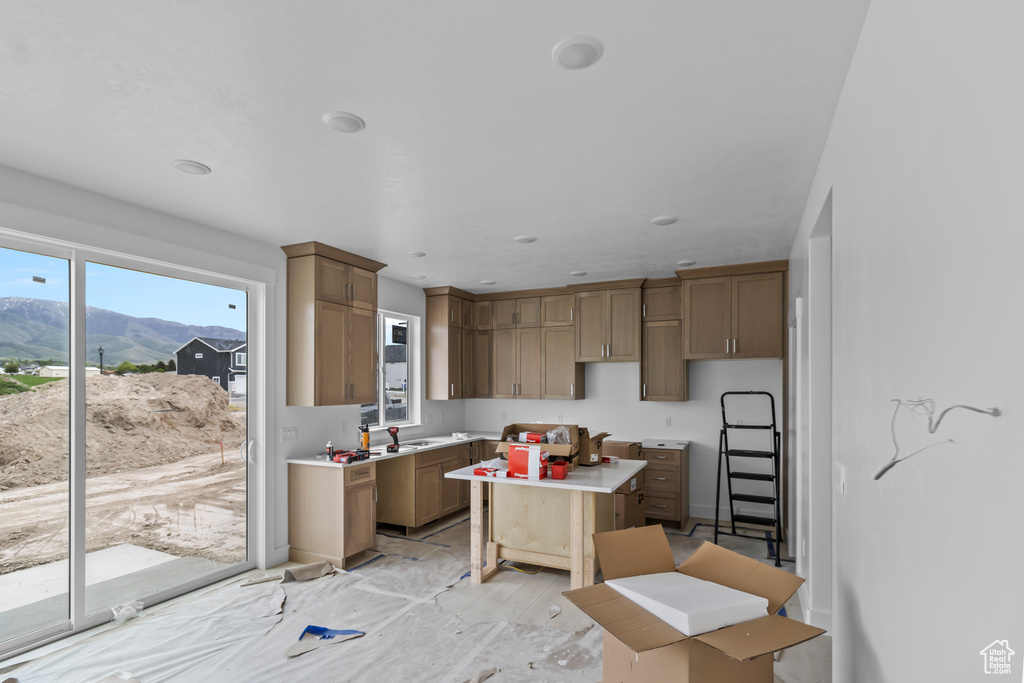 Kitchen with a mountain view, a kitchen island, and a sink