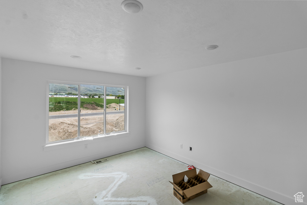 Unfurnished room featuring baseboards